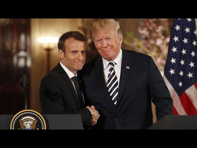 Trump and Macron share an awkward handshake and a kiss