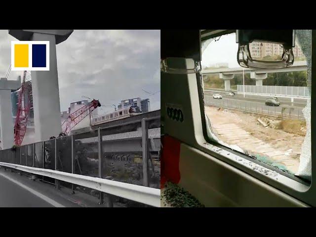 Construction crane falls onto moving train in Shanghai