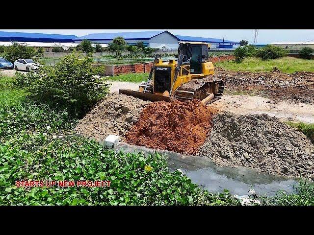 Amazing power bulldozer starts pushing new project landfill with dump trucks