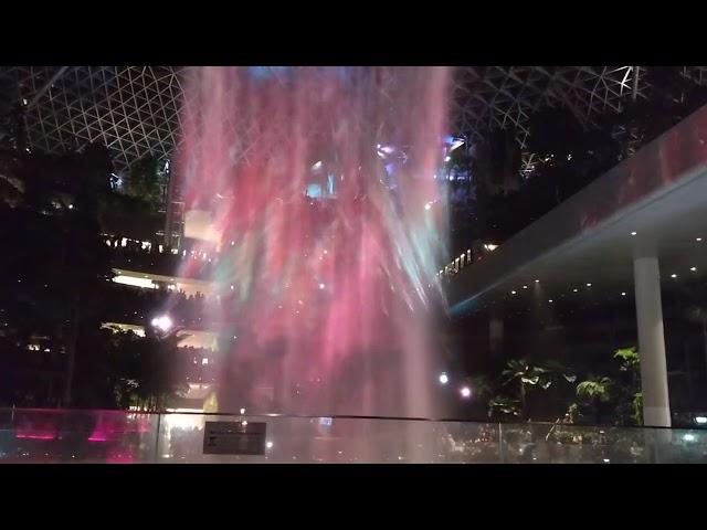 Train inside building + light show. Changi Jewel waterfall with airport train.