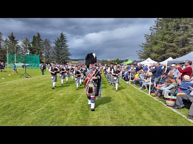 Drum Major leads Strathisla Pipe Band playing Liberton Polka during 2024 Dufftown Highland Games