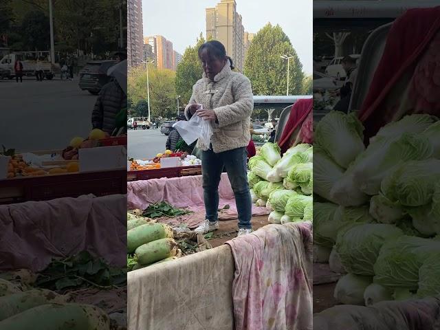 Vendors selling radishes and cabbage on the streets of Xi'an