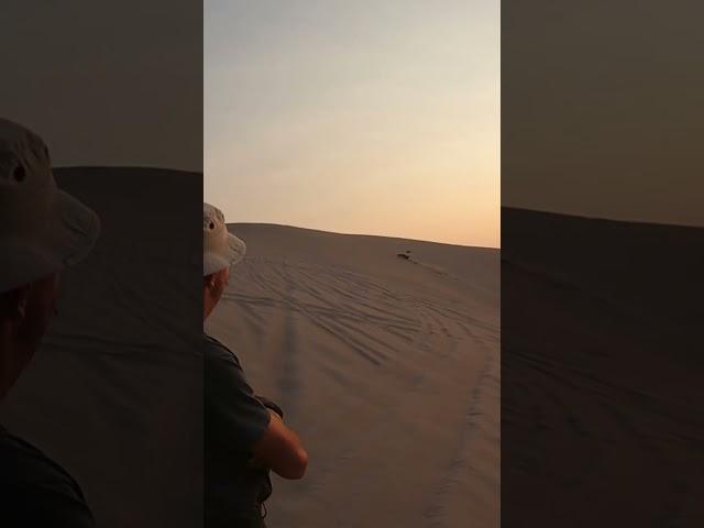 Sand rail wheelies up dune