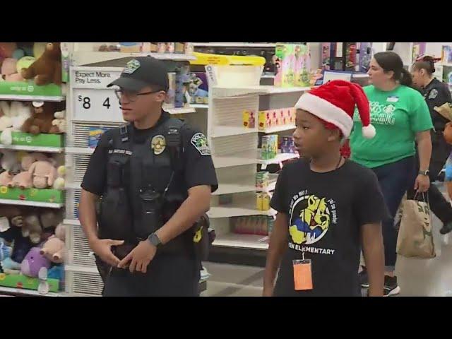 200 students team up with APD officers for annual 'Shop With a Cop'