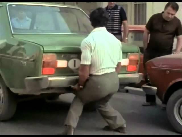 Franco Columbu lifts a car in Pumping Iron