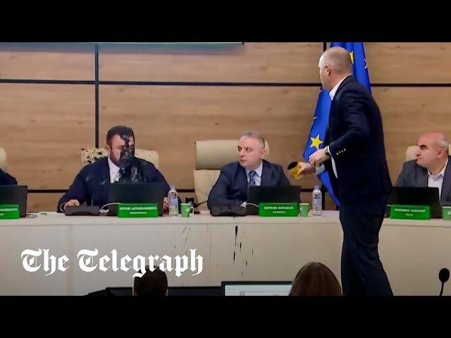 Shocking moment Georgian politician throws paint over election chief