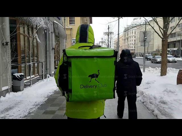 Delivery club courier fast speed walking on the city street