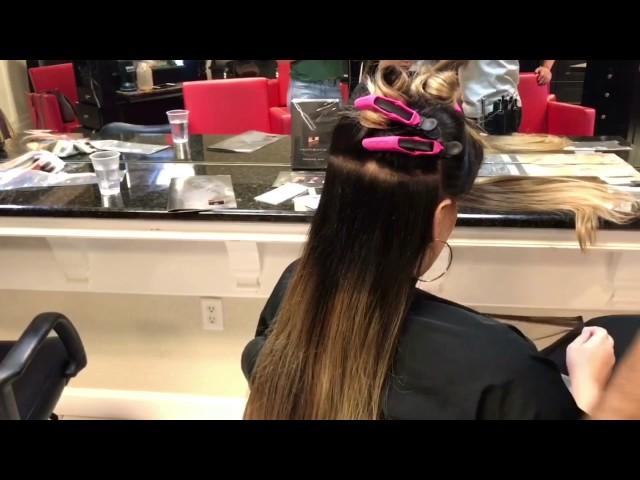 Orlando hair extension educator Nima training at a local salon.