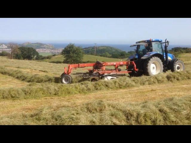 Farmers making hay / straw Hafodty Farm CL caravan site Colwyn Bay Wales Massey Ferguson New Holland