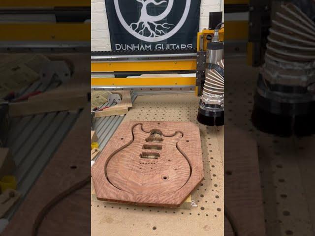 Pocketing, outline, and top carving of Dunham Guitars Artisan Guitar in curly redwood