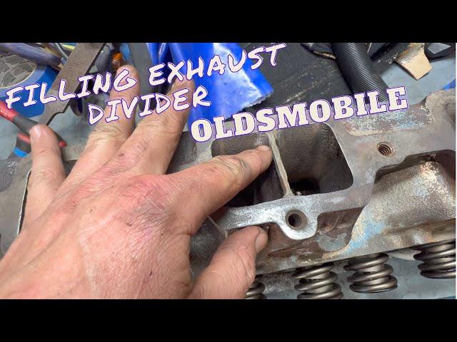 Oldsmobile head work, filling exhaust flange divider.