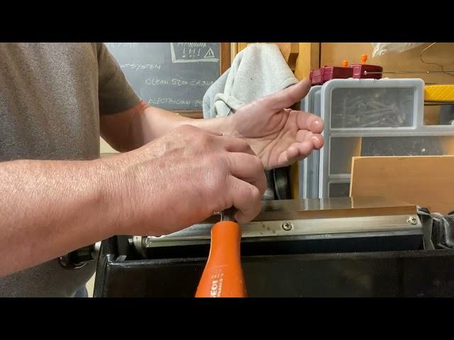 Sharpening chisels on a whetstone.