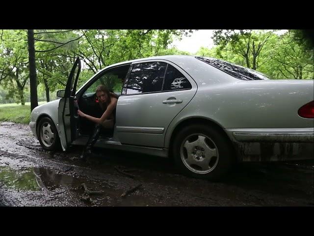 Brunette tries to drive Mercedes through muddy road and gets stuck