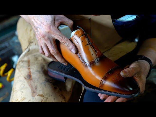 Handmade shoes craftsman with 50 years of experience. Process of making brown shoes