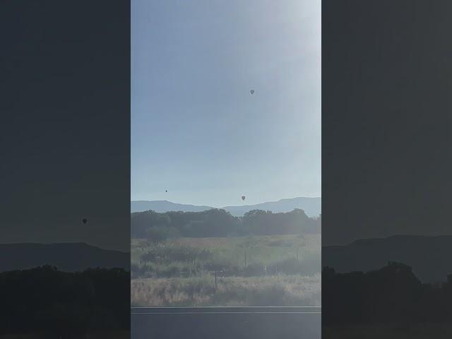 Hot air balloons floating over the Manzano mountains in New Mexico #HotAirBallooning#nmtrue