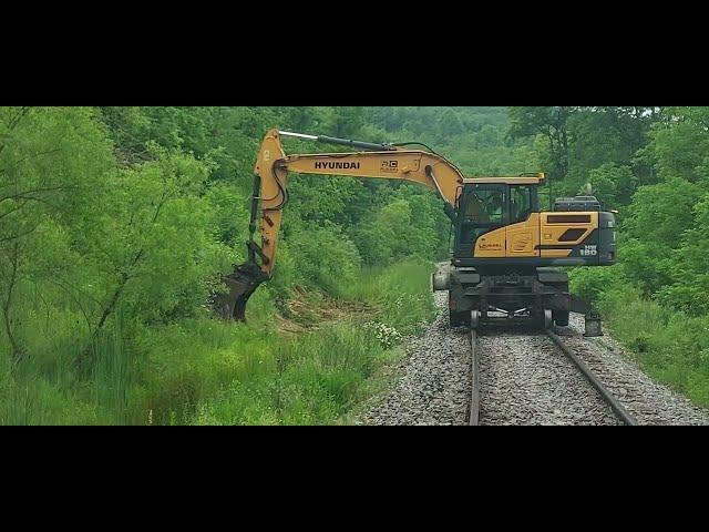 Trains and a Hi Rail Excavator Ditching along the Track