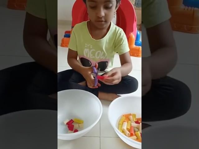 Snipping slippery pasta turns giggles into growth! ️