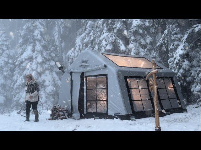 HOT TENT CAMP WITH A STOVE IN HEAVY SNOW