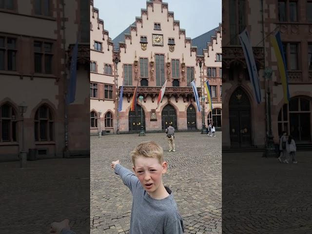 11 yr gives tour of Romerberg in Old Town Frankfurt Germany