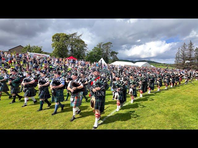 Drum Majors lead massed pipe bands salute to Chieftain opening 2024 Dufftown Highland Games Scotland