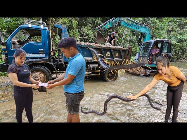 the driver and the girl Driving an excavator leveling the ground,Car carrying sand for farmers.