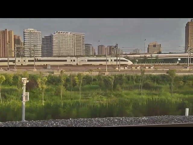 Leaving Xi'an North Station China on our 350kph high speed train alongside another High Speed Train