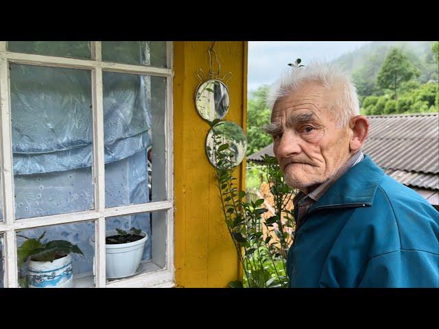 Happy old age of an elderly couple of shepherd in a mountain village far from civilization