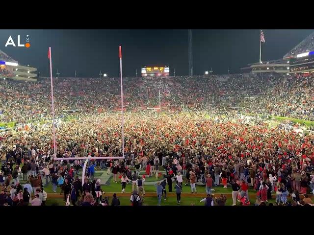 Auburn fans rush the field after Tigers upset No. 15 Texas A&M in 4 overtimes