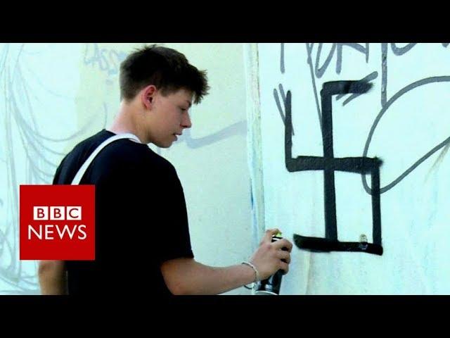 Berlin street artist group cleverly undo swastika graffiti- BBC News