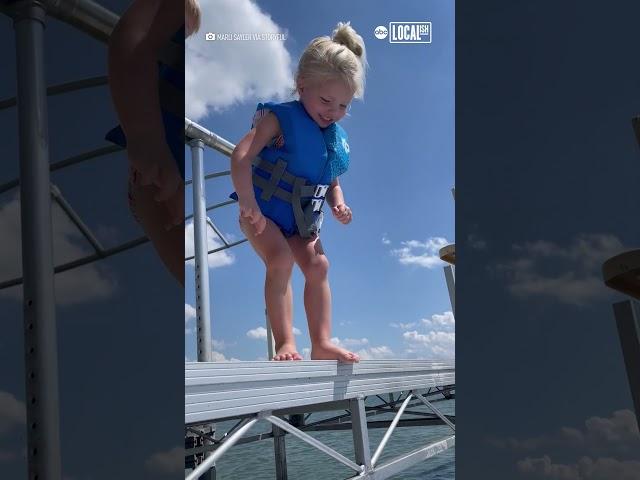 Little girl overcomes fear of jumping into lake