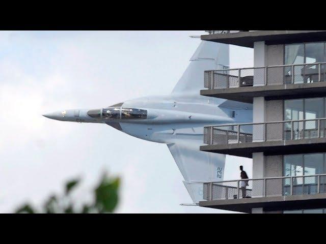 Crazy fighter jet pilot low pass between Australian city buildings