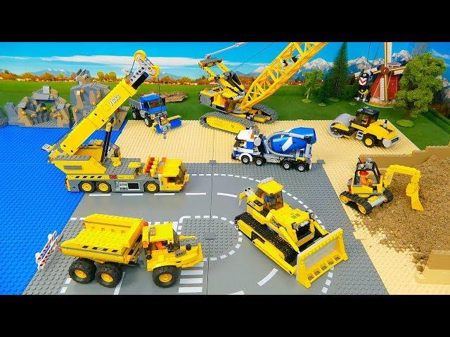 Construction vehicles build a Lego Bridge