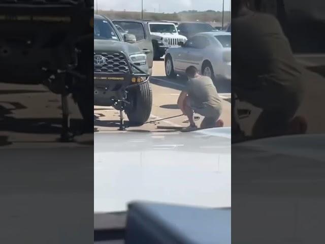 Changing tire in school parking lot after friends call you at lunch and tell you your tire is flat