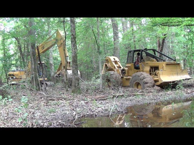 Trackhoe Pulling Out The Skidder! Caterpillar 518 320 Stuck Logging Wet Mud