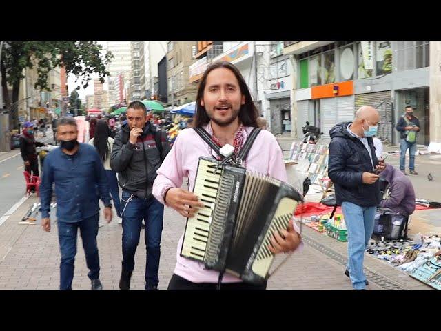 A Colombian guy is performing a folk Ukrainian song in the middle of Bogota