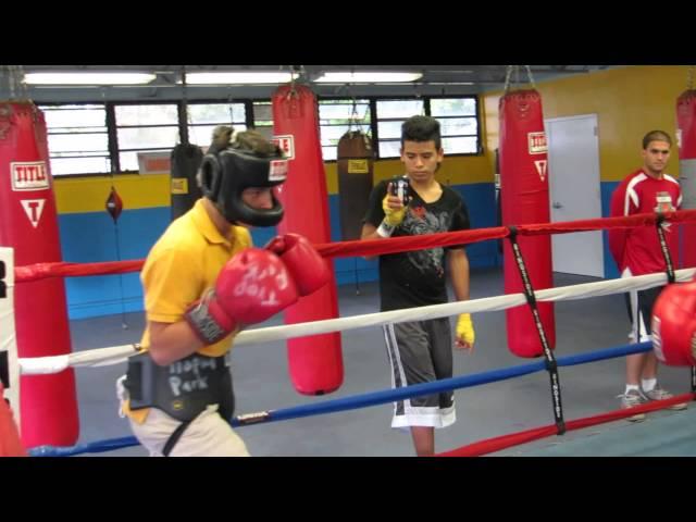 Alejandro Cepero 12 year old (yellow t-shirt) boxing with 18 year old boxer (white t-shirt)