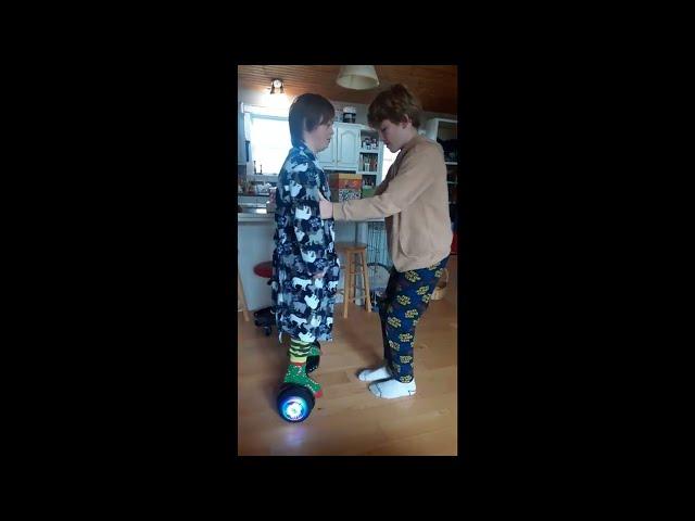 Griffin teaching Turner to ride hoverboard.