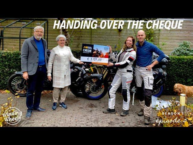 Handing over the cheque - S1E5