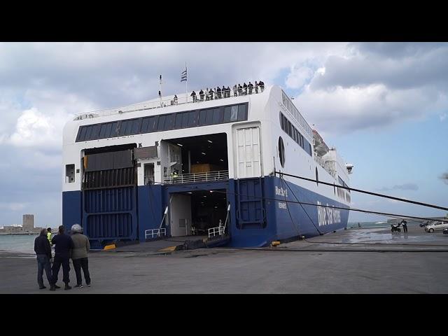 BlueStar Ferry docking in Port Rhodos in stormy weather with rope demolition