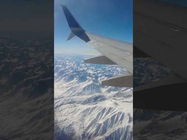 snowy sierra. full airplane window view video on the channel! #snow #mountains #shorts