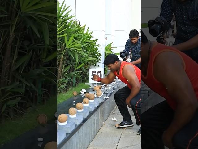 Most coconuts smashed with one hand in one minute - 122 by Abheesh P. Dominic 