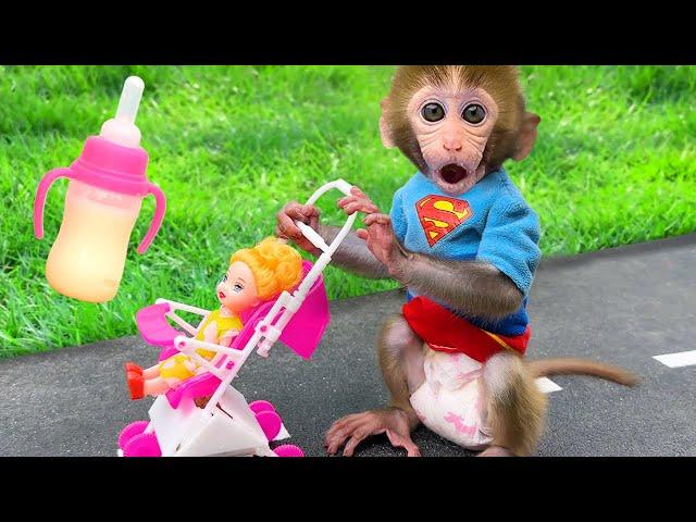 Monkey Baby Bon Bon feeds baby with a bottle and plays with ducklings in the pool