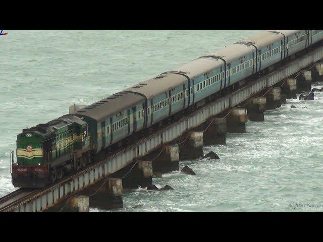 Train crossing Pamban bridge on a windy day.