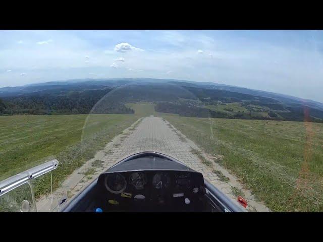 Sailplane does a gravity take off from top of a hill