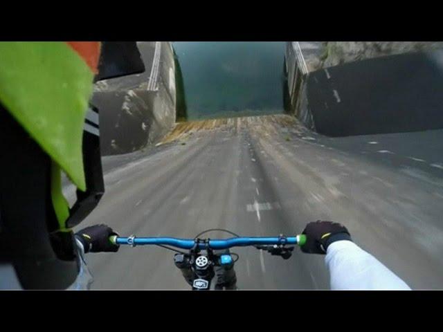 Ciclista desafia morte em descida vertical em represa vista por quase 5 milhões de pessoas