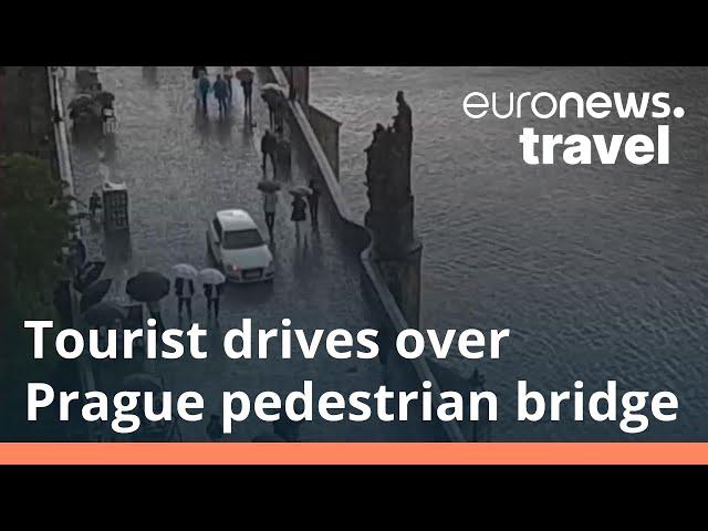 Watch as a tourist illegally drives over Prague's iconic Charles Bridge - then gets fined