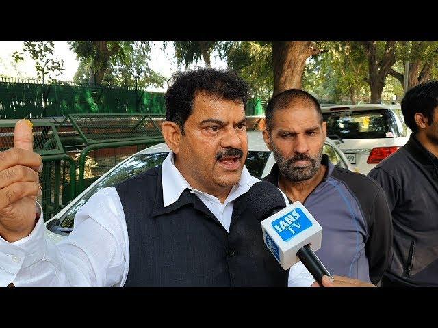 Jagdish Sharma distributes sweets outside the residence of Sonia Gandhi