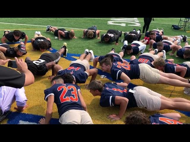 Genesee County sheriff Chris Swanson challenges high school football players to push-up contest