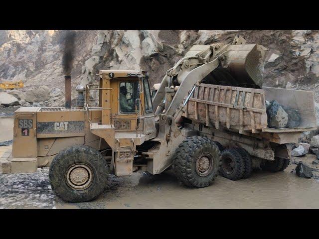 Caterpillar 966D Wheel Loader Loading Huge Stone On Mitsubishi Fuso Dumpers Trucks