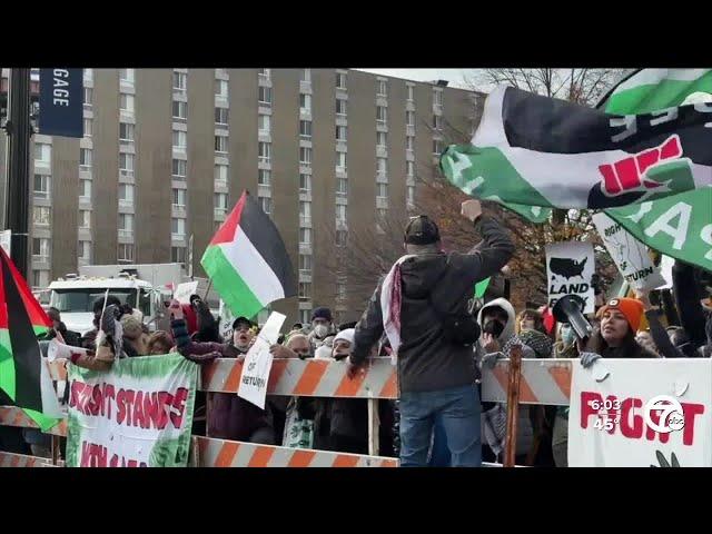 Protesters line parade route in downtown Detroit